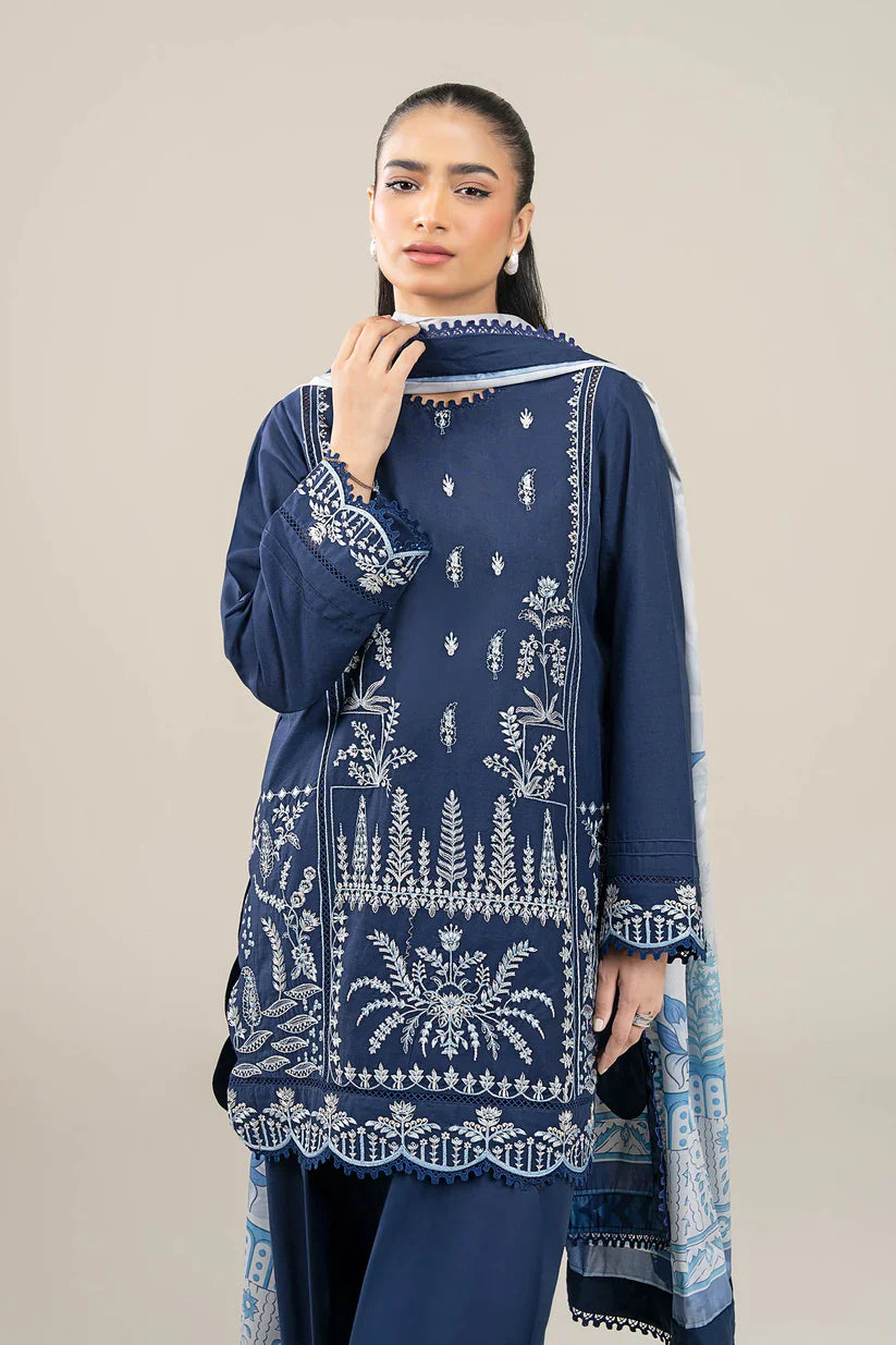 Woman wearing a navy blue embroidered outfit against a beige background